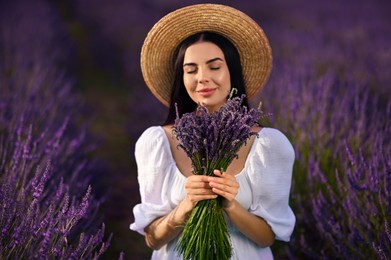 Photo of Beautiful young woman with bouquet in lavender field