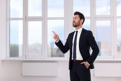 Photo of Real estate agent pointing in new apartment