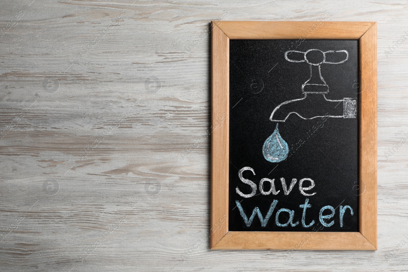 Photo of Blackboard with words Save Water and drawn tap on wooden table, top view. Space for text