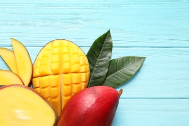 Flat lay composition with mango on color wooden background