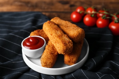 Photo of Plate of cheese sticks and sauce on table, closeup