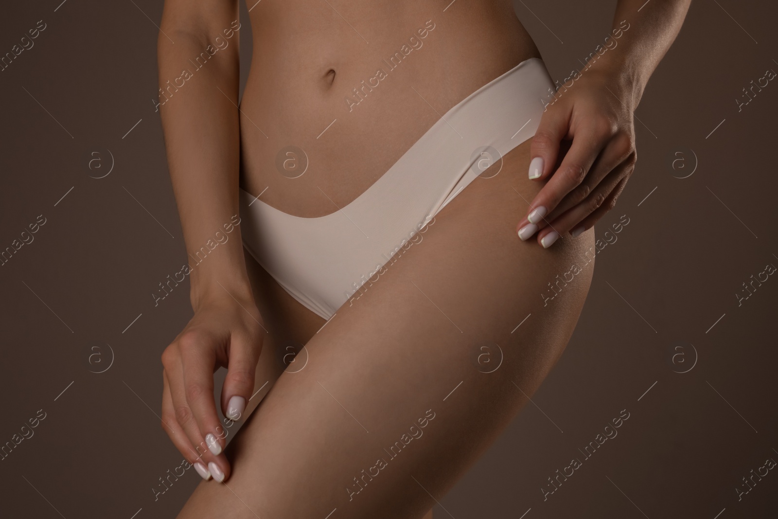 Photo of Slim woman with smooth skin in underwear on beige background, closeup. Cellulite problem concept