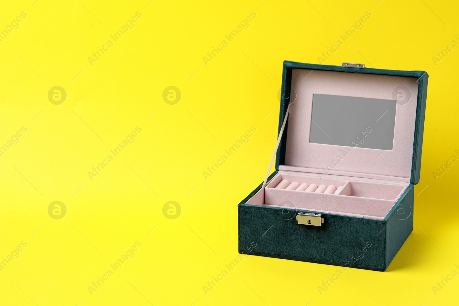Photo of One empty jewelry box on yellow background, space for text