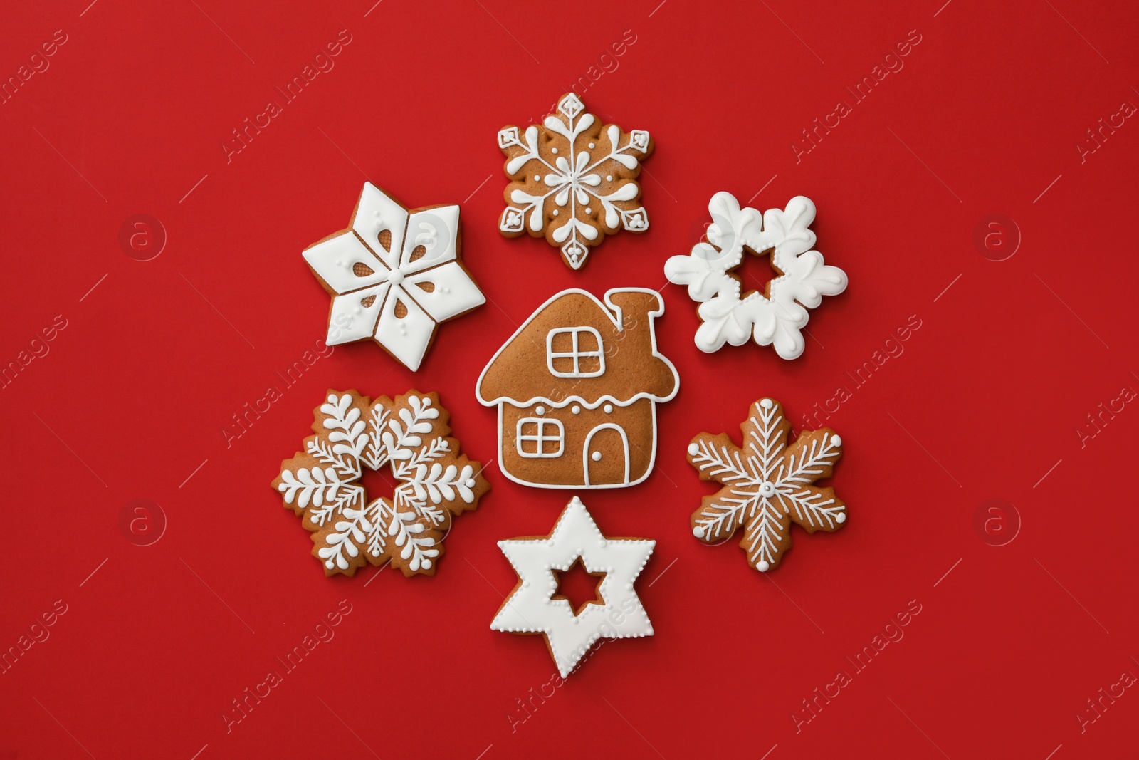 Photo of Different Christmas gingerbread cookies on red background, flat lay