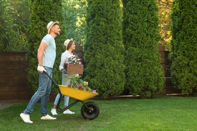 Photo of Happy couple working together in green garden