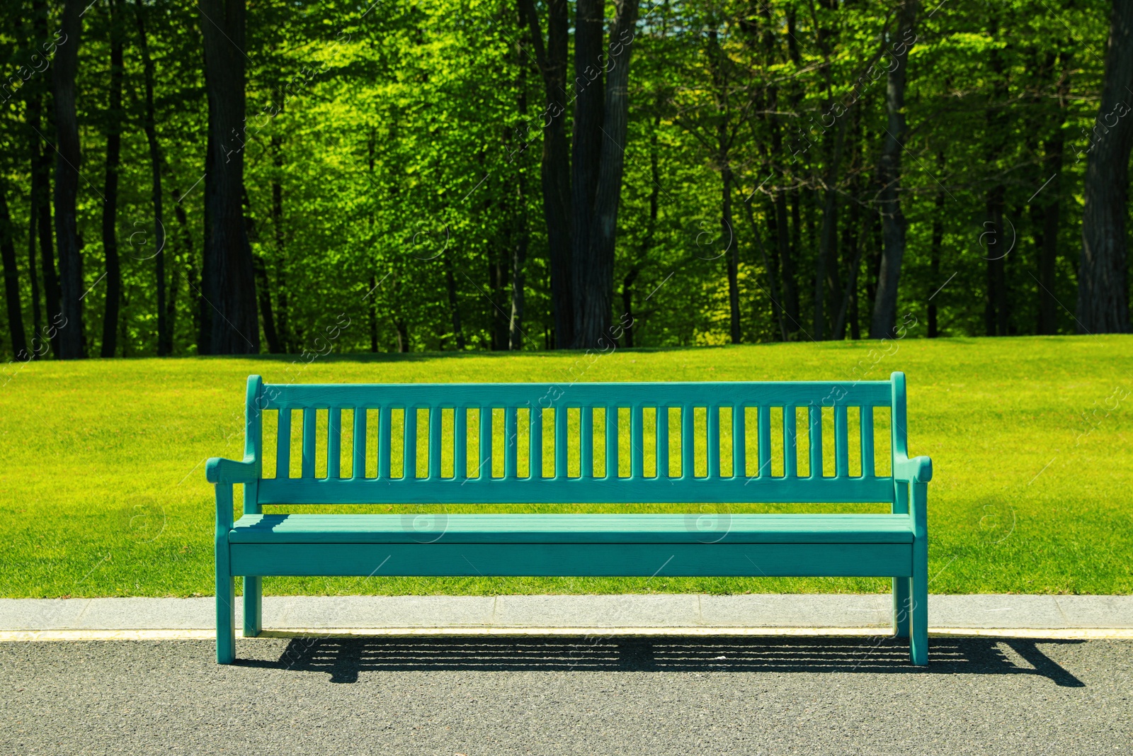 Photo of Beautiful view of light blue wooden bench in park