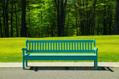 Beautiful view of light blue wooden bench in park