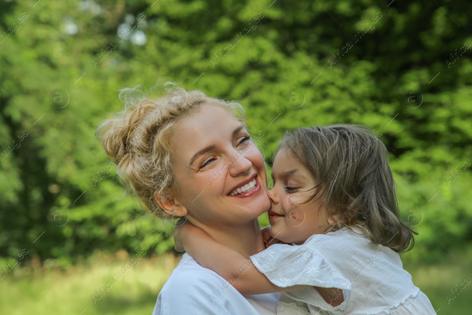 Photo of Portrait of happy mother with her cute daughter outdoors