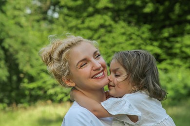 Photo of Portrait of happy mother with her cute daughter outdoors