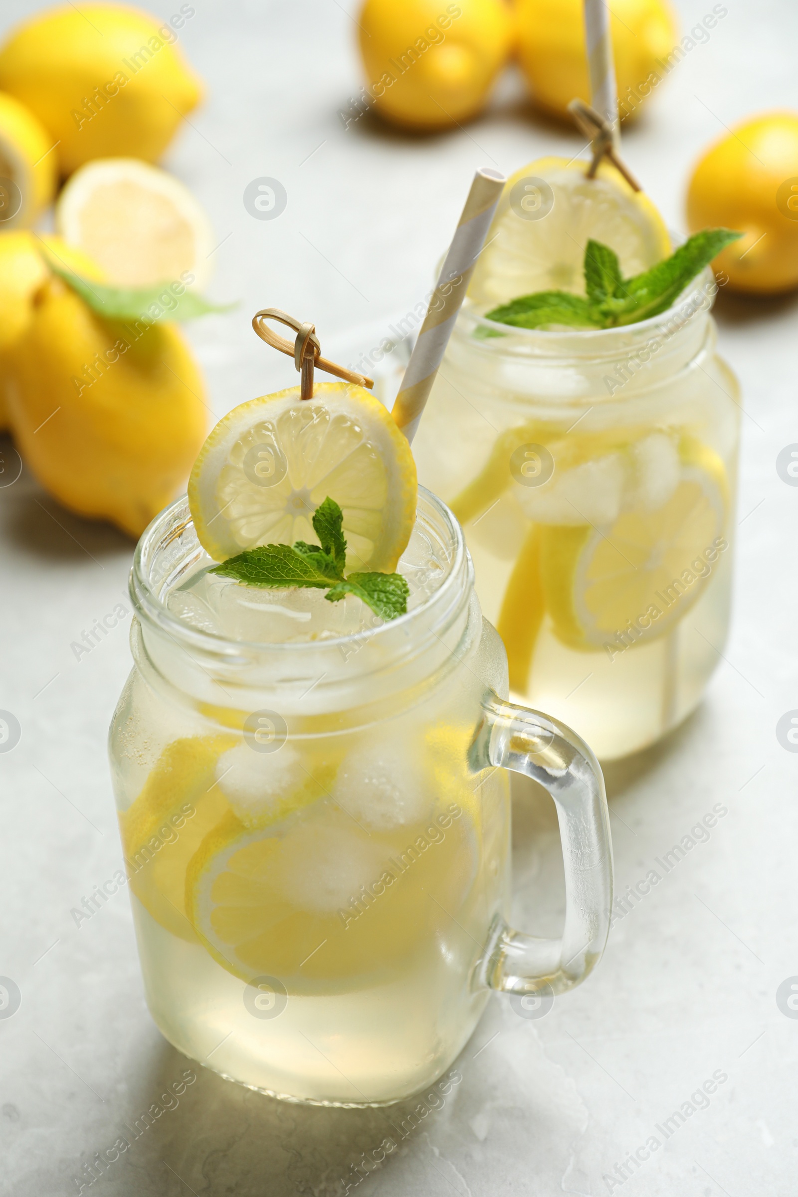 Photo of Natural lemonade with mint on light grey marble table. Summer refreshing drink