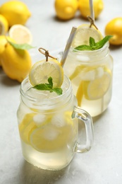 Natural lemonade with mint on light grey marble table. Summer refreshing drink