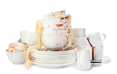 Set of dirty dishes with spaghetti leftovers isolated on white