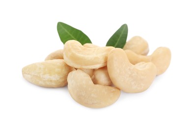 Pile of tasty organic cashew nuts and green leaves isolated on white