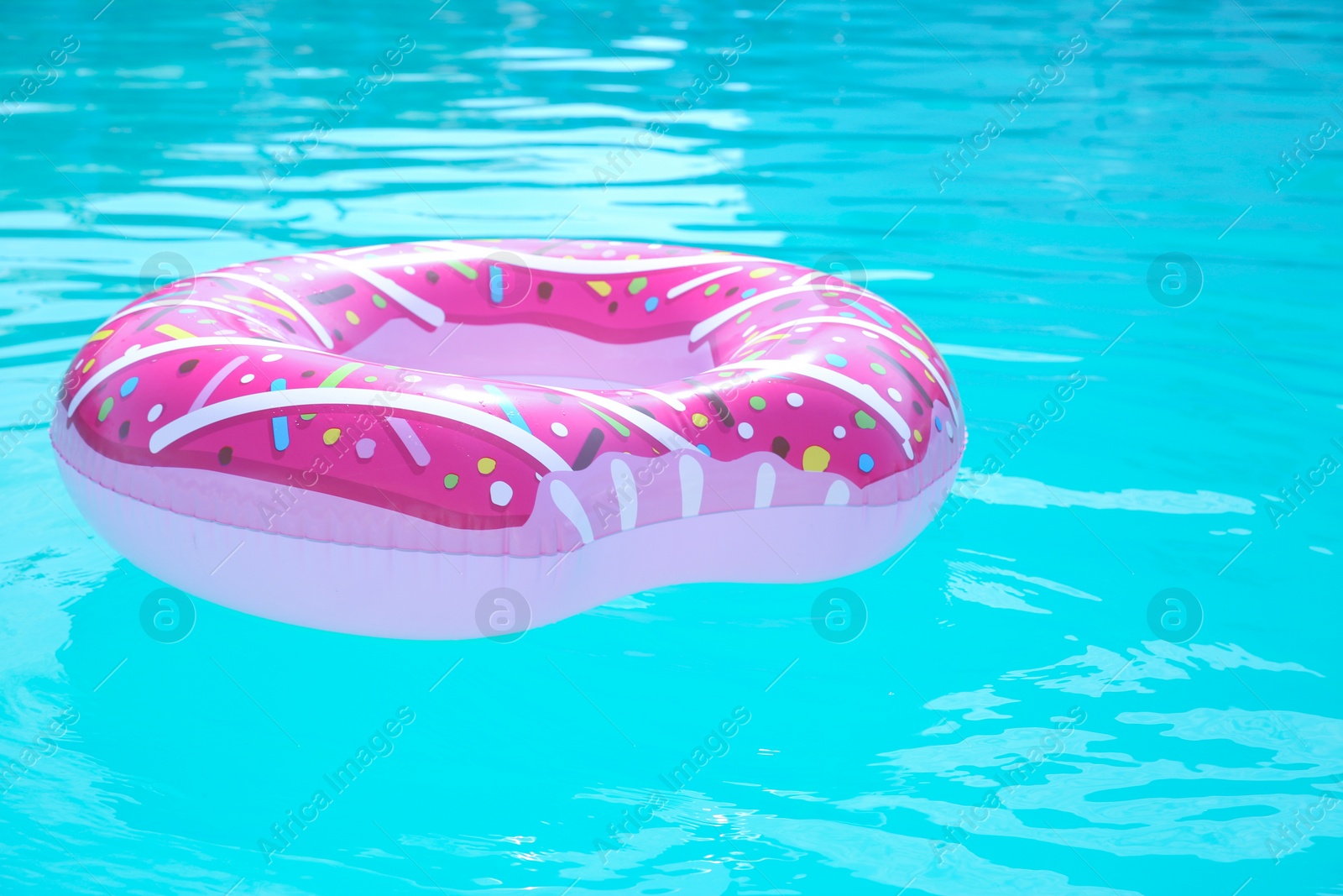 Photo of Inflatable ring in swimming pool on sunny day