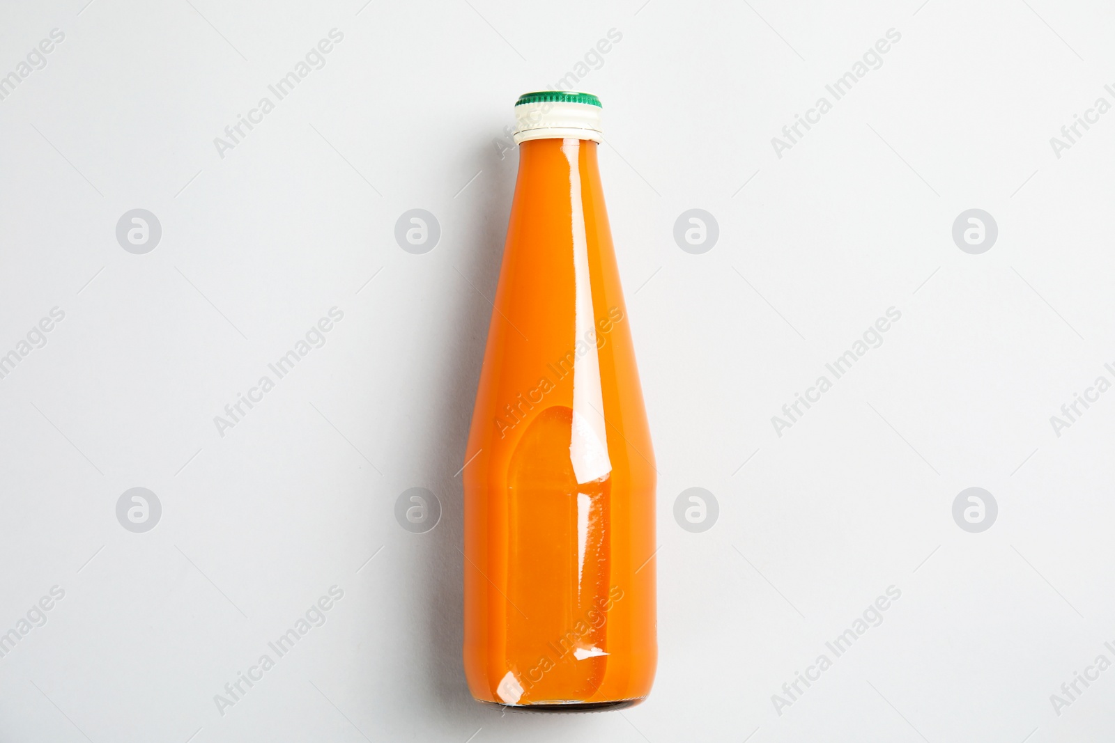 Photo of One bottle with tasty drink on color background, top view