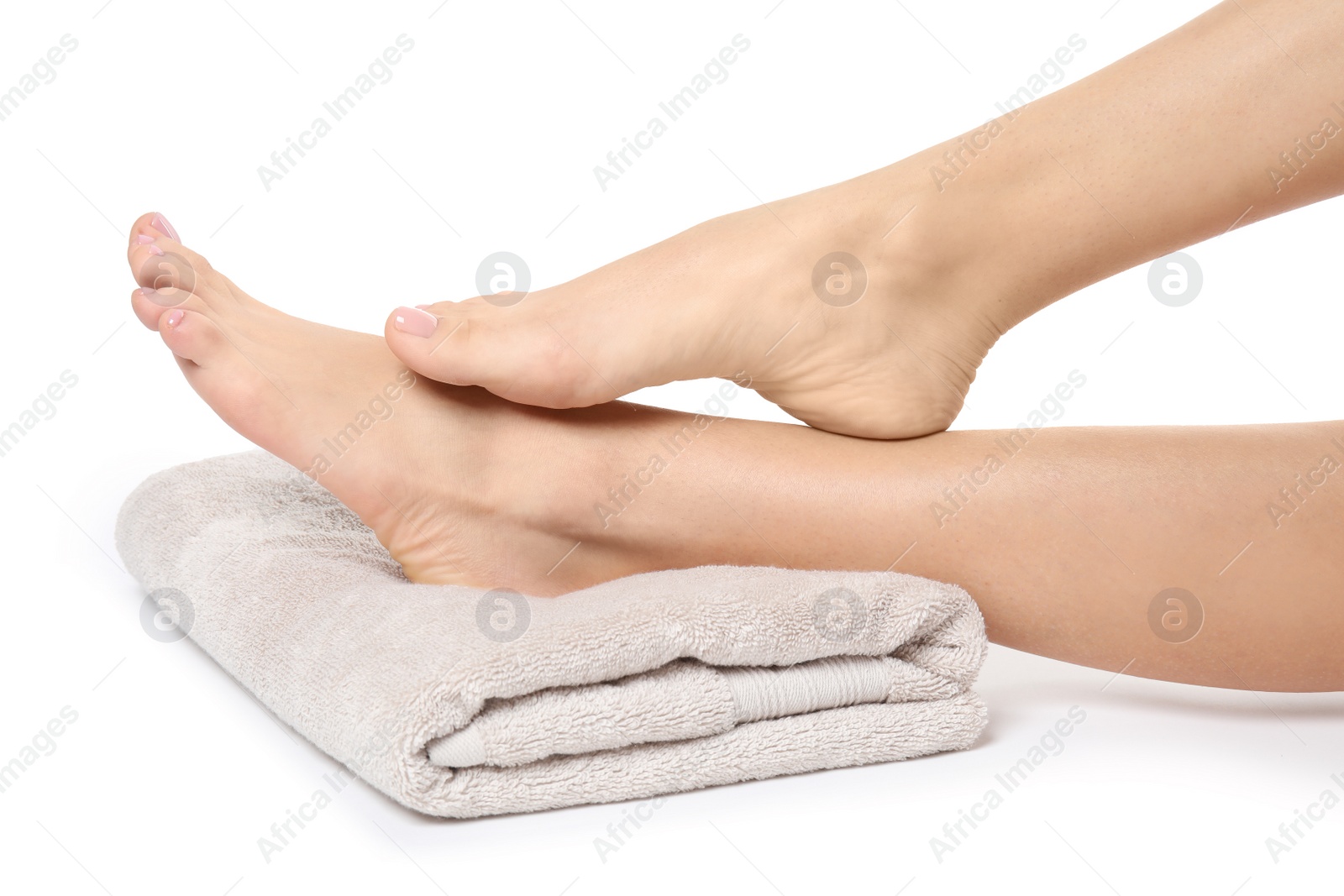 Photo of Woman with smooth feet and towel on white background, closeup. Spa treatment