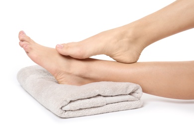 Photo of Woman with smooth feet and towel on white background, closeup. Spa treatment