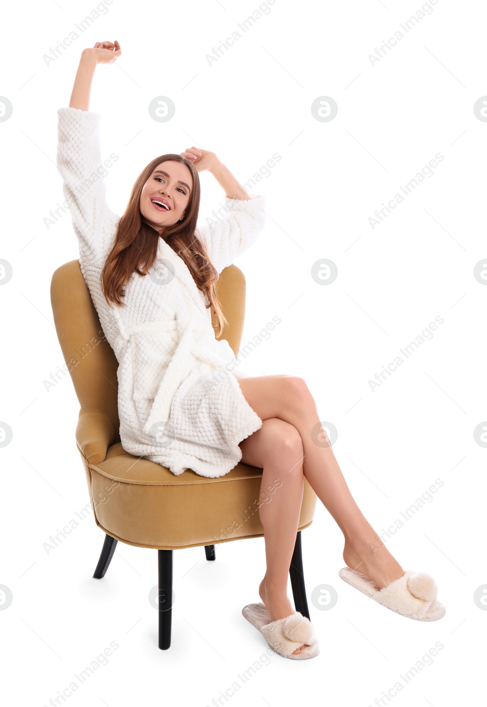 Photo of Young woman in bathrobe stretching on white background