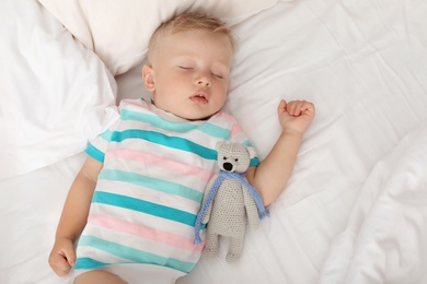 Photo of Little child sleeping in bed at home