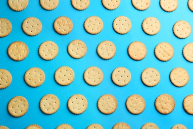 Delicious crackers on light blue background, flat lay