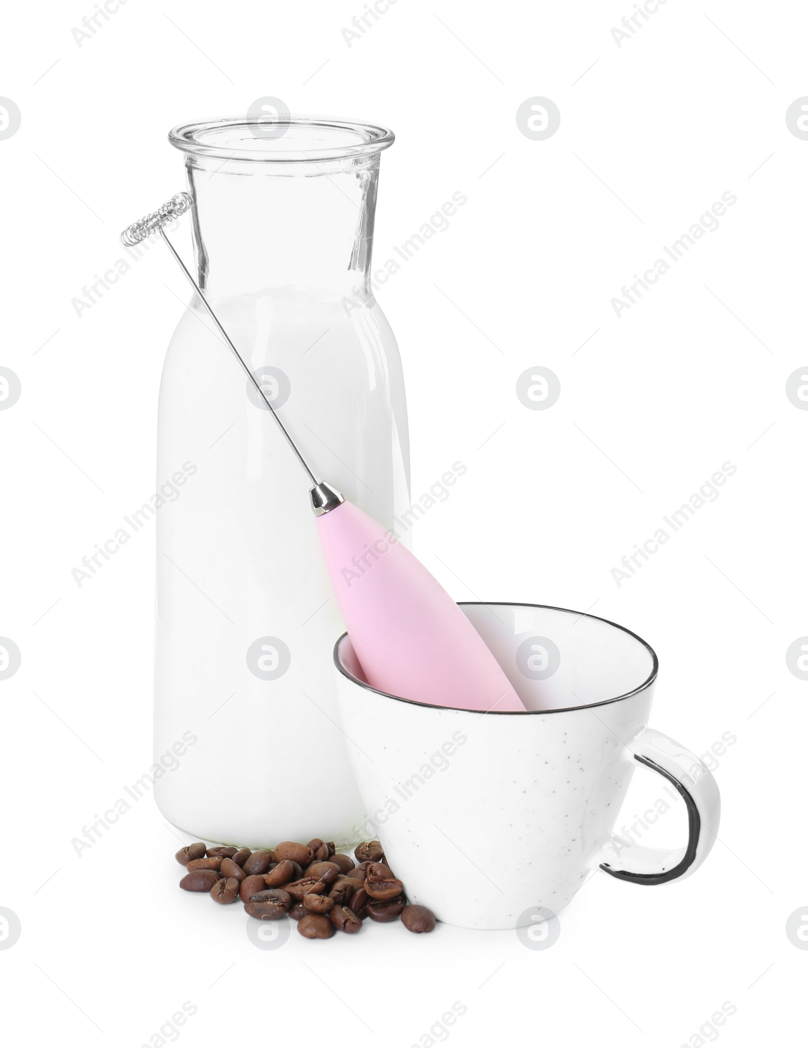 Photo of Pink mini mixer (milk frother), cup, coffee beans and bottle isolated on white