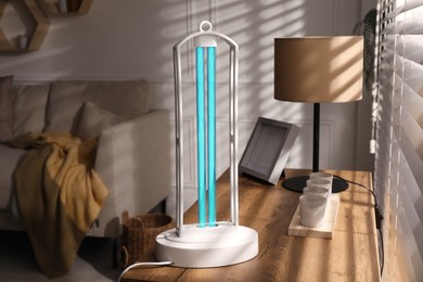 Photo of UV lamp for light sterilization on table in living room