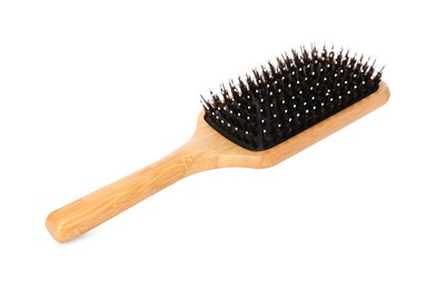 Photo of One new wooden hairbrush isolated on white