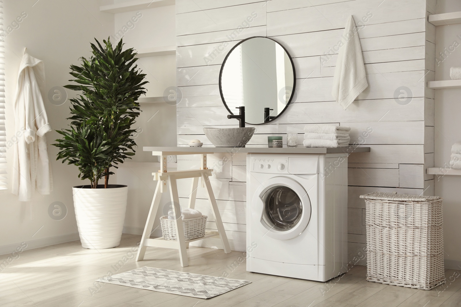 Photo of Stylish bathroom interior with modern washing machine