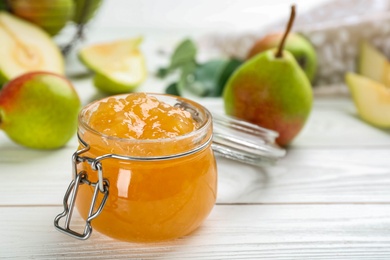 Delicious pear jam on white wooden table, closeup. Space for text