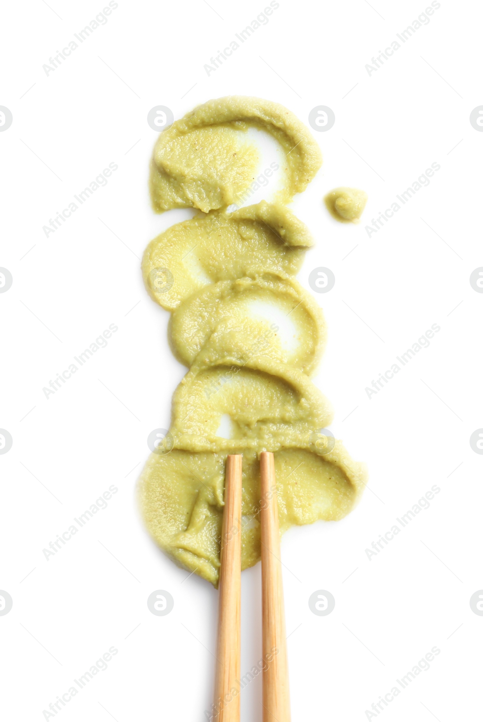 Photo of Delicious spicy wasabi and chopsticks on white background, top view. Traditional sauce