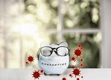 Image of Piggy bank with medical mask. Money saving during coronavirus outbreak