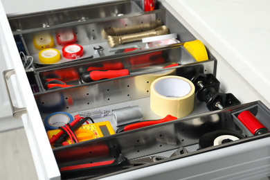 Photo of Set of instruments in open desk drawer indoors