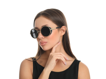 Beautiful young woman wearing sunglasses on white background