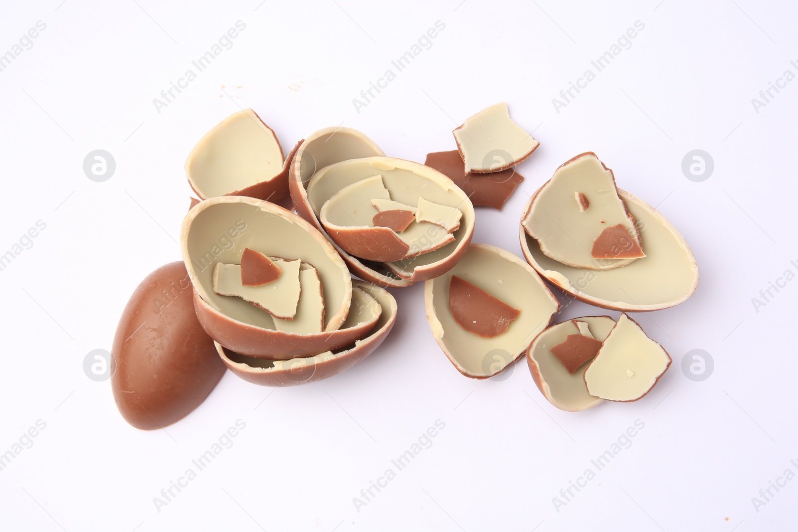 Photo of Sveti Vlas, Bulgaria - July 3, 2023: Broken halves of Kinder Surprise Eggs isolated on white, top view