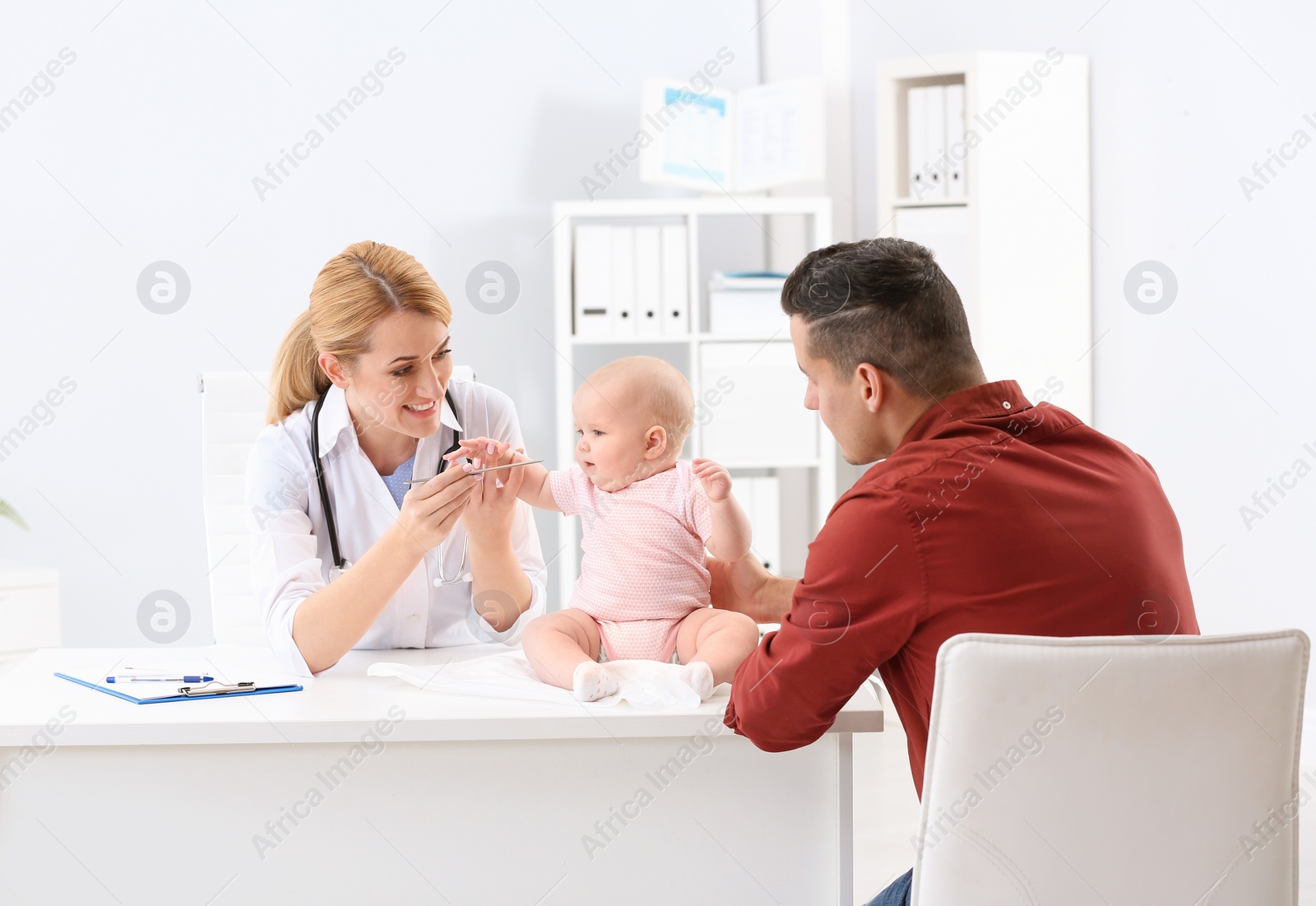 Photo of Man with his baby visiting children's doctor in hospital