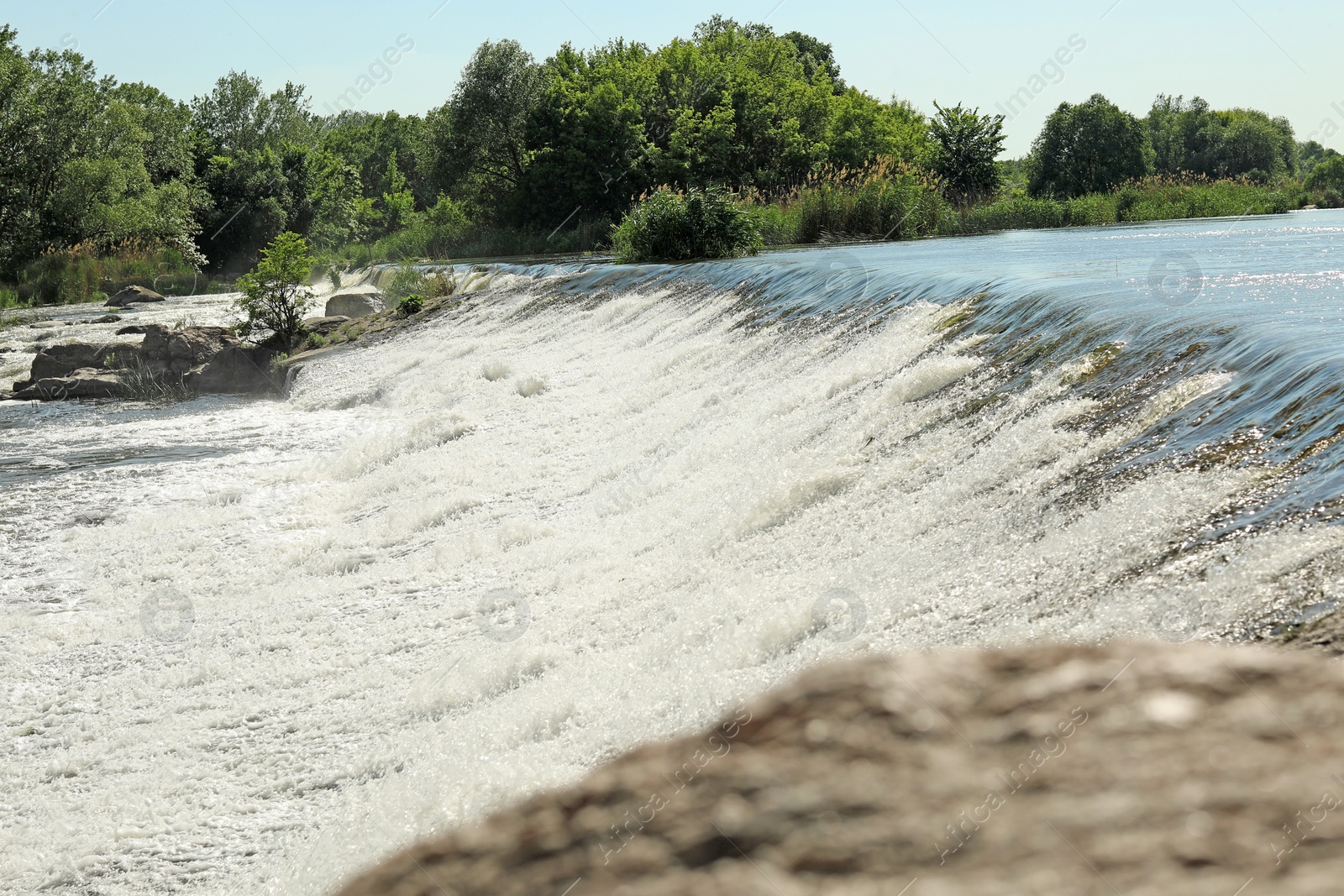 Photo of Fast river with rapids on sunny day