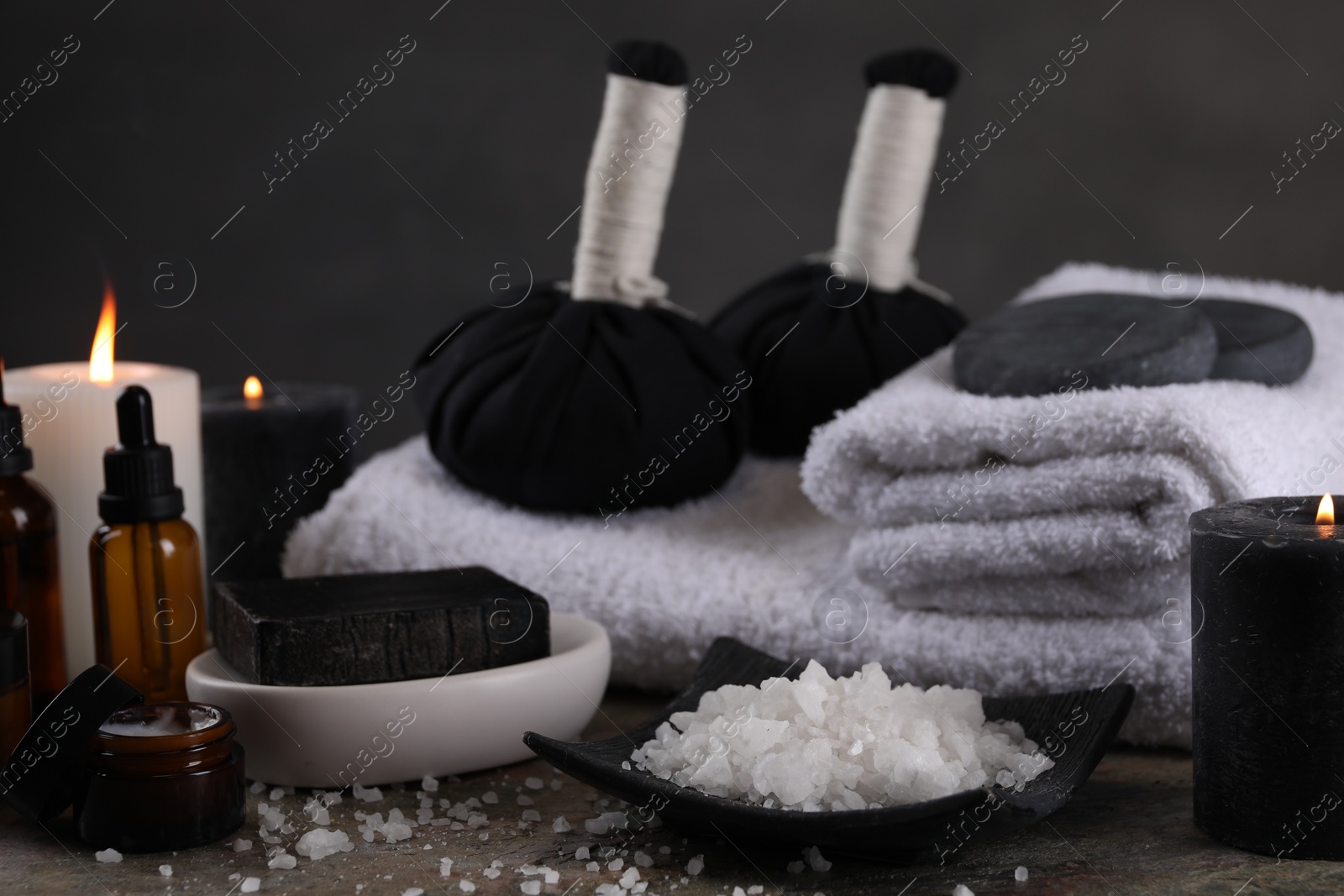 Photo of Composition with different spa products and burning candles on grey table