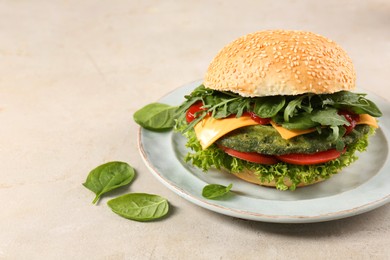 Tasty vegetarian burger with spinach cutlet, cheese and vegetables on white table, space for text