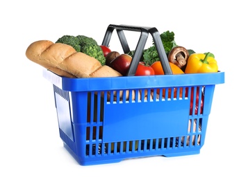 Shopping basket with grocery products on white background