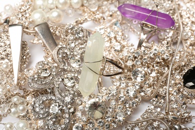 Different stylish jewelry as background, closeup view