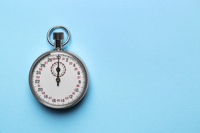 Photo of Vintage timer on light blue background, top view. Space for text