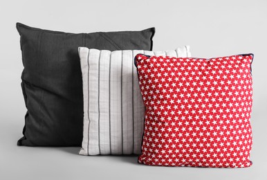 Photo of Different stylish soft pillows on grey background