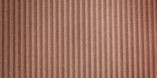 Wall paper design. Brown corrugated sheet of cardboard as background