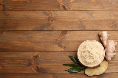 Photo of Flat lay composition with fresh and dry ginger on wooden table. Space for text