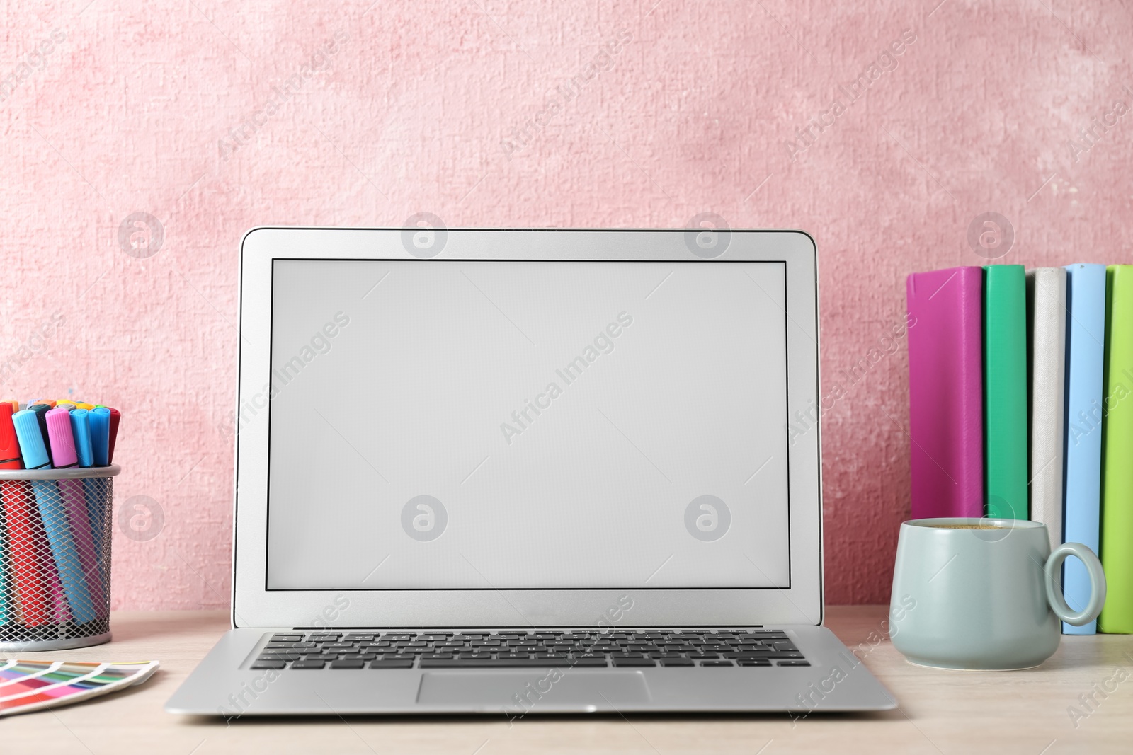 Photo of Modern laptop and cup of coffee on white table. Space for design