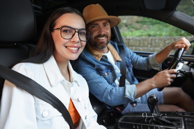 Photo of Happy couple enjoying trip together by car, selective focus