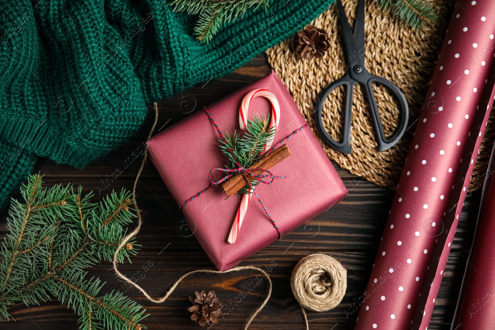 Photo of Flat lay composition with beautifully wrapped gift box on wooden table