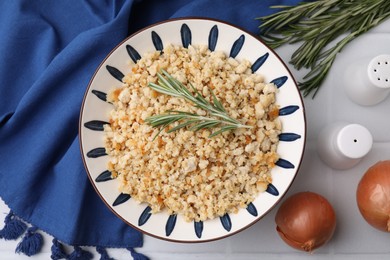 Photo of Fried ground meat in bowl and products on white tiled table, flat lay