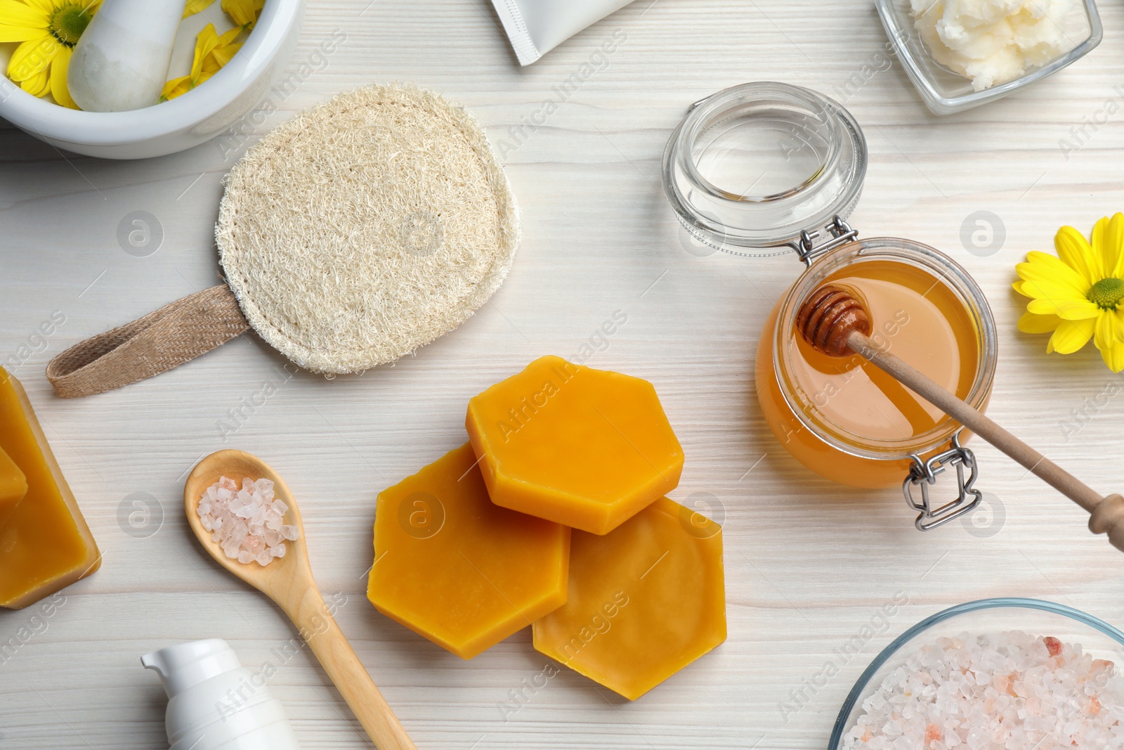 Photo of Flat lay composition with beeswax on white wooden table