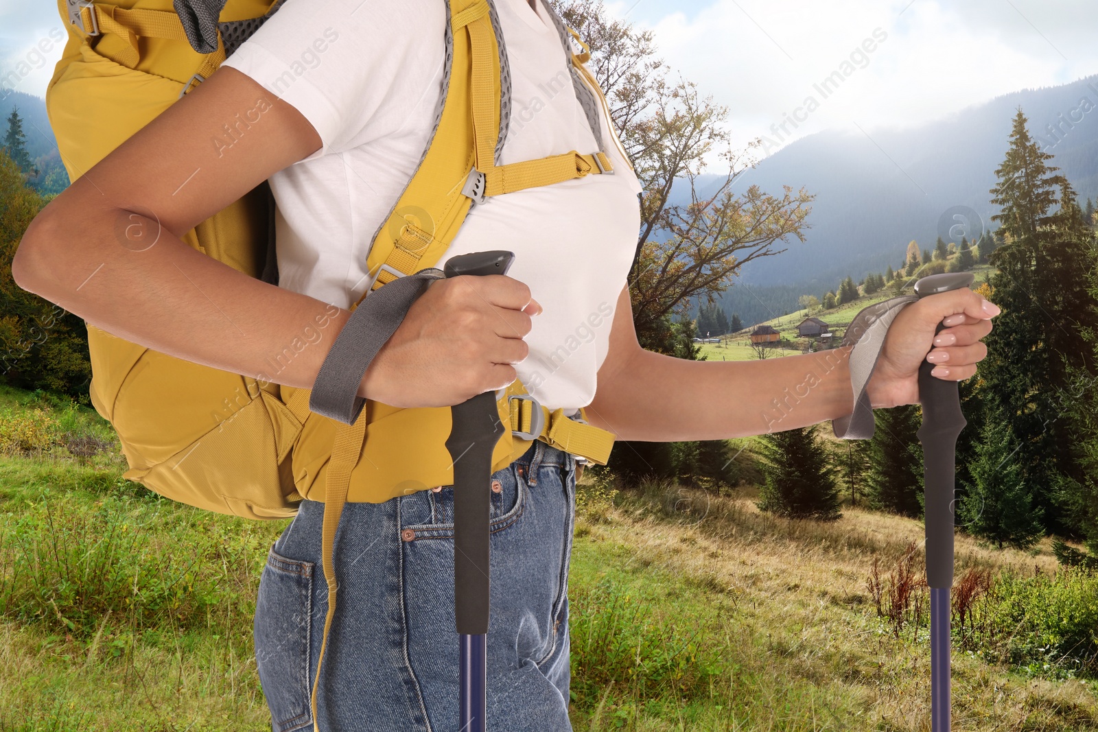 Image of Woman with backpack and trekking poles in mountains on sunny day, closeup